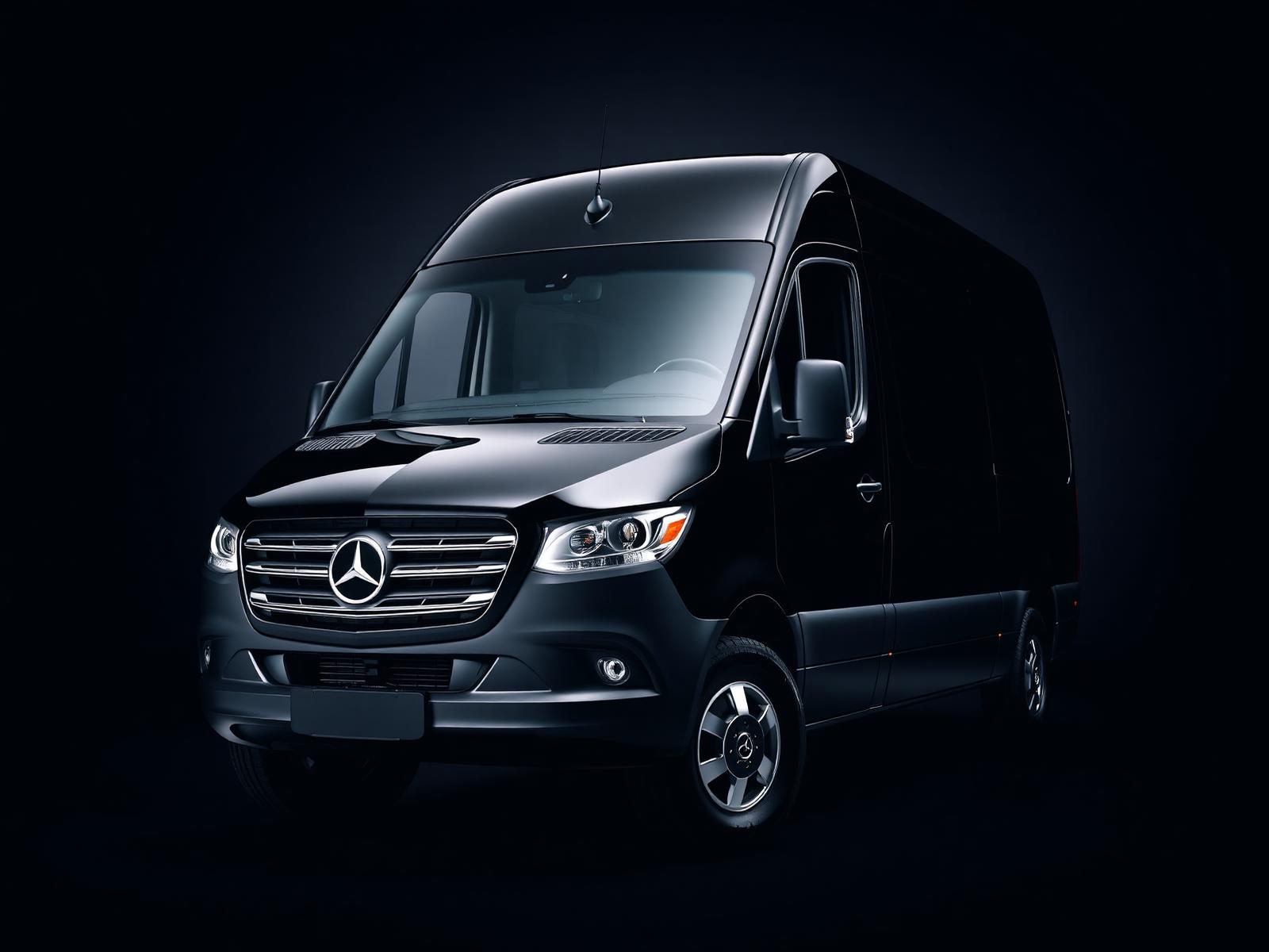 Black Mercedes-Benz Sprinter luxury passenger van in studio lighting